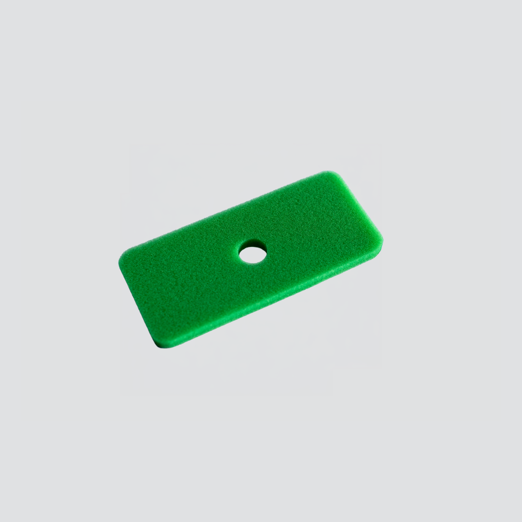 A bright green rectangular foam insert with rounded corners and a single circular hole, shown on a light gray background.