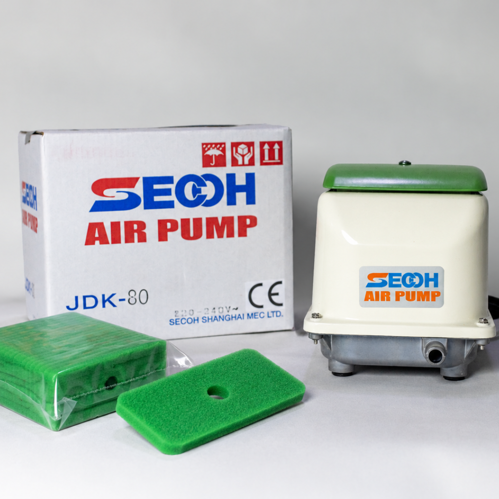 Green replacement air filter sitting next to Secoh JDK80 Air Pump