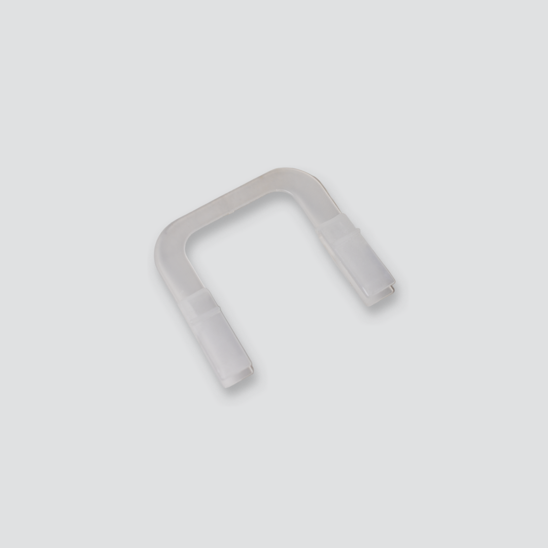 Clear U-shaped actuating rod locater on a light grey background